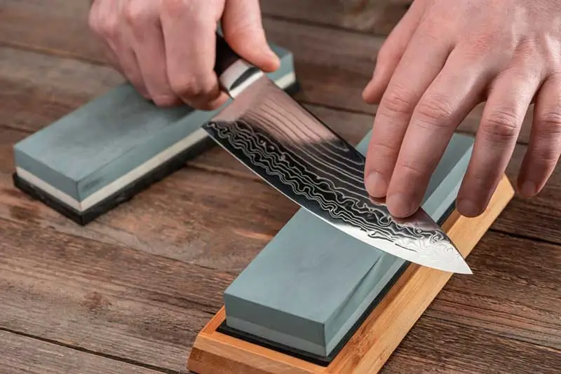 man sharpening a knife